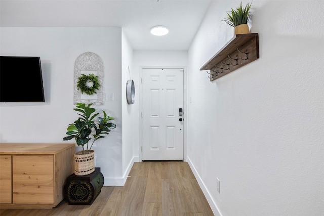 interior space with baseboards and wood finished floors