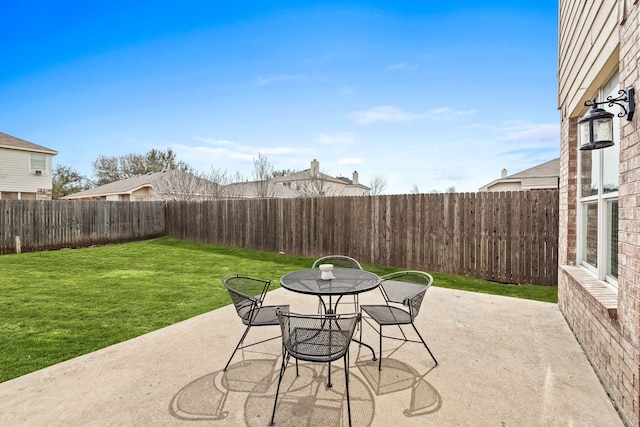 view of patio with outdoor dining area and a fenced backyard