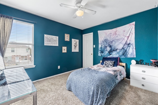 bedroom with a ceiling fan, carpet, and baseboards