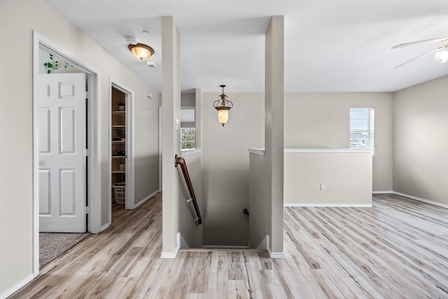 interior space with wood finished floors, baseboards, and ceiling fan