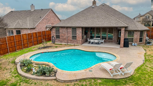 view of swimming pool with a fenced backyard and a patio