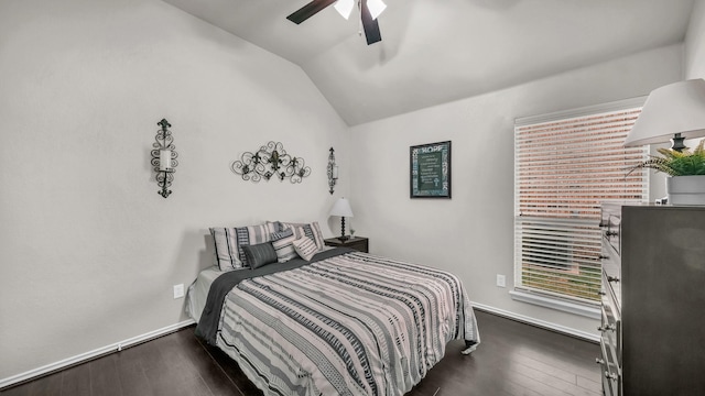 bedroom with a ceiling fan, vaulted ceiling, baseboards, and dark wood-type flooring