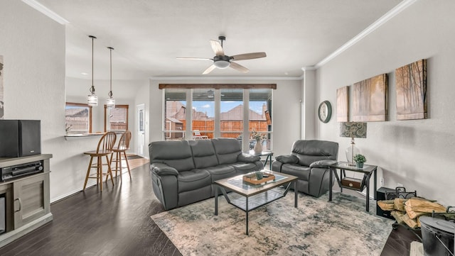 living room featuring a view of city, ornamental molding, a ceiling fan, wood finished floors, and baseboards