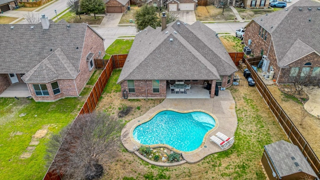 view of pool featuring a patio, a lawn, and a fenced backyard