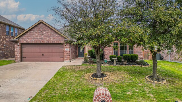 view of property hidden behind natural elements featuring brick siding, a garage, concrete driveway, and a front lawn