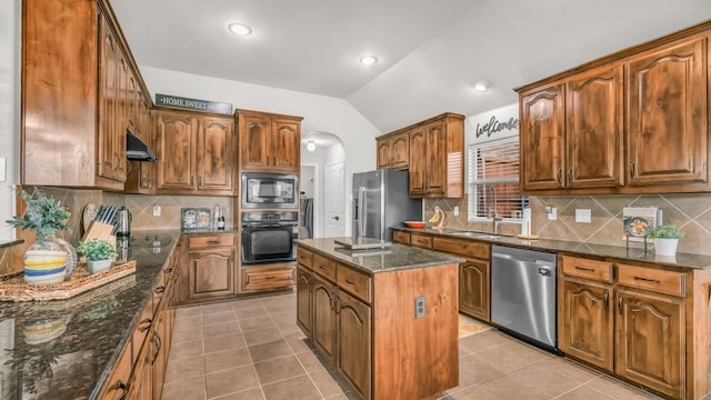 kitchen featuring lofted ceiling, black appliances, light tile patterned floors, and under cabinet range hood