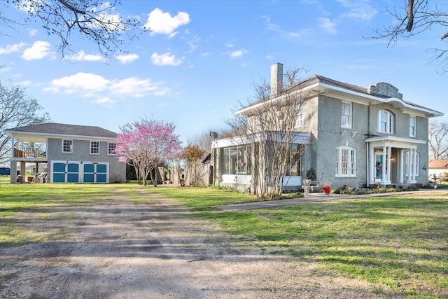 view of home's exterior featuring a lawn, dirt driveway, and a chimney