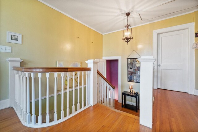 300 5th St, Kerens, TX 75144 - hall with visible vents, ornamental molding, hardwood / wood-style flooring, and an upstairs landing
