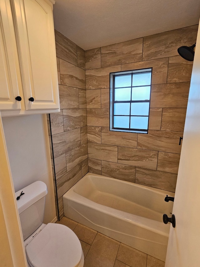 full bath featuring tile patterned floors, toilet, and washtub / shower combination