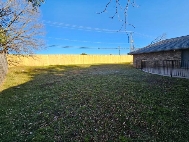 view of yard with a fenced backyard