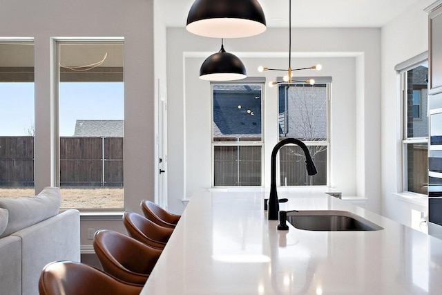 interior space with hanging light fixtures, an inviting chandelier, and a sink