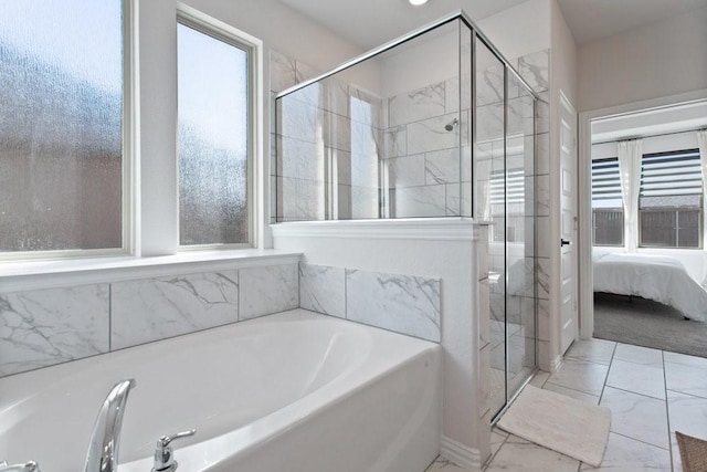 ensuite bathroom with a stall shower, marble finish floor, a healthy amount of sunlight, and a bath