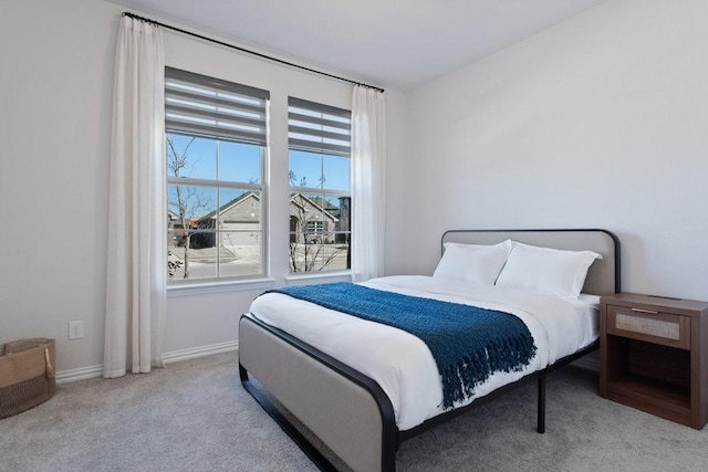 carpeted bedroom featuring baseboards