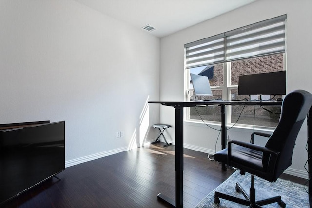 office space with visible vents, baseboards, and wood finished floors