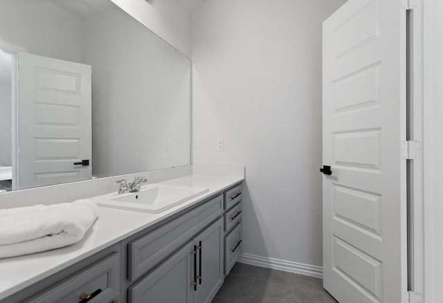 bathroom with tile patterned floors, vanity, and baseboards