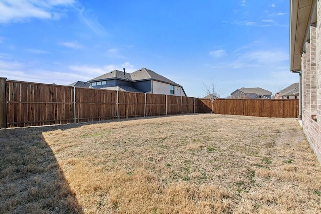 view of yard with a fenced backyard