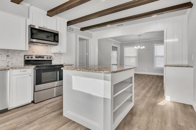 kitchen with white cabinetry, beamed ceiling, light wood-type flooring, and stainless steel appliances