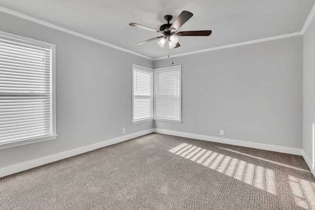 unfurnished room featuring carpet, a ceiling fan, baseboards, and ornamental molding