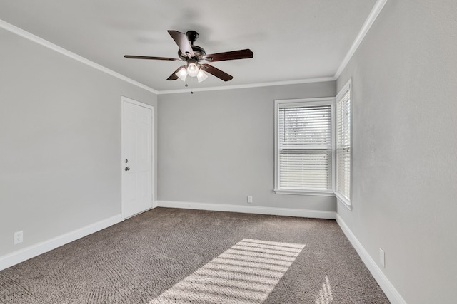 spare room featuring carpet flooring, a ceiling fan, baseboards, and ornamental molding