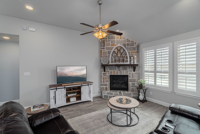 4152 Sanders Dr, Celina, TX 75009 - living room with wood finished floors, lofted ceiling, a stone fireplace, and ceiling fan