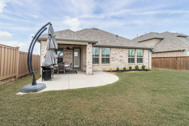 4152 Sanders Dr, Celina, TX 75009 - back of property featuring a yard, brick siding, a fenced backyard, and a patio area