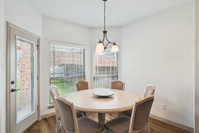 dining space featuring baseboards and wood finished floors