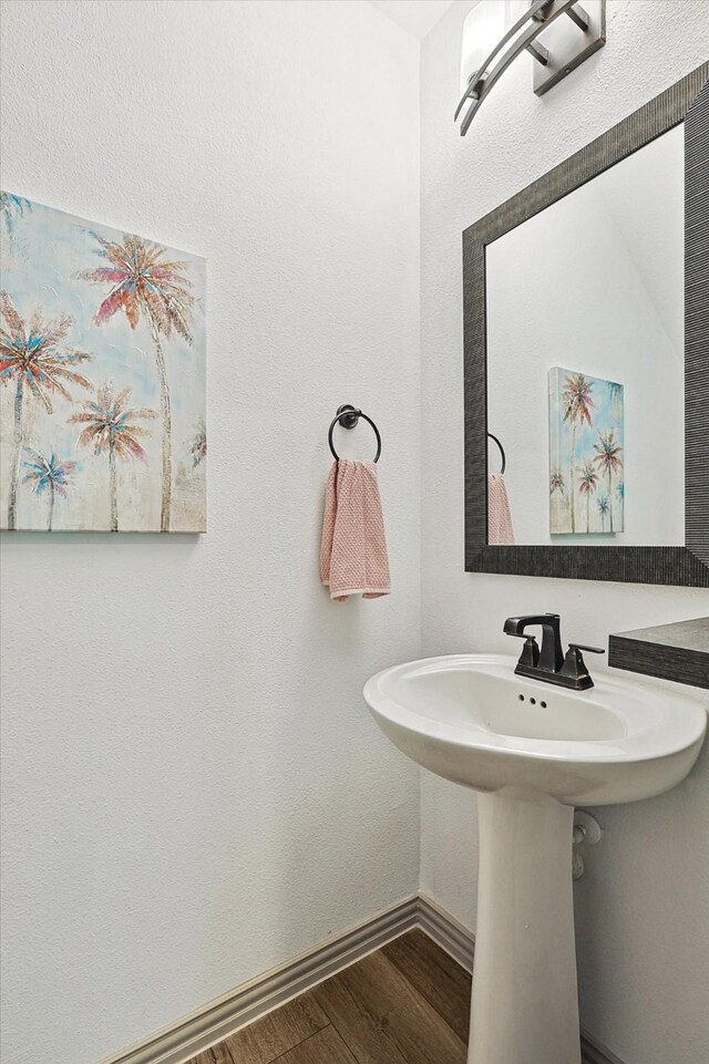 bathroom featuring wood finished floors and baseboards