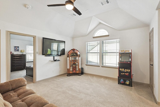 living area featuring visible vents, lofted ceiling, and carpet flooring