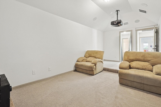 living room featuring vaulted ceiling, carpet, visible vents, and baseboards