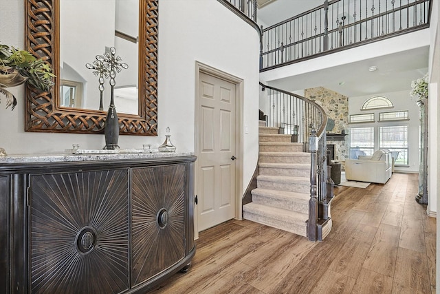 6015 Liverpool St, Celina, TX 76227 - entryway featuring a towering ceiling, light wood-type flooring, stairs, and bar area