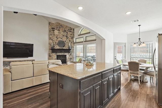 6015 Liverpool St, Celina, TX 76227 - kitchen with dark wood finished floors, a fireplace, freestanding refrigerator, hanging light fixtures, and recessed lighting