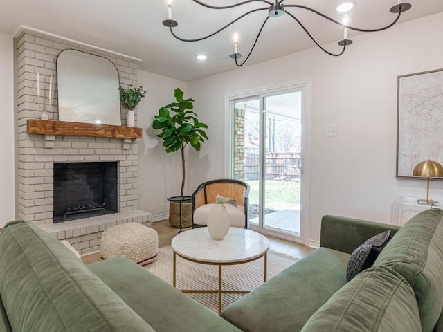 living room with baseboards, a brick fireplace, and wood finished floors