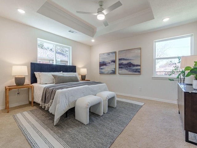 bedroom featuring recessed lighting, baseboards, crown molding, and a tray ceiling