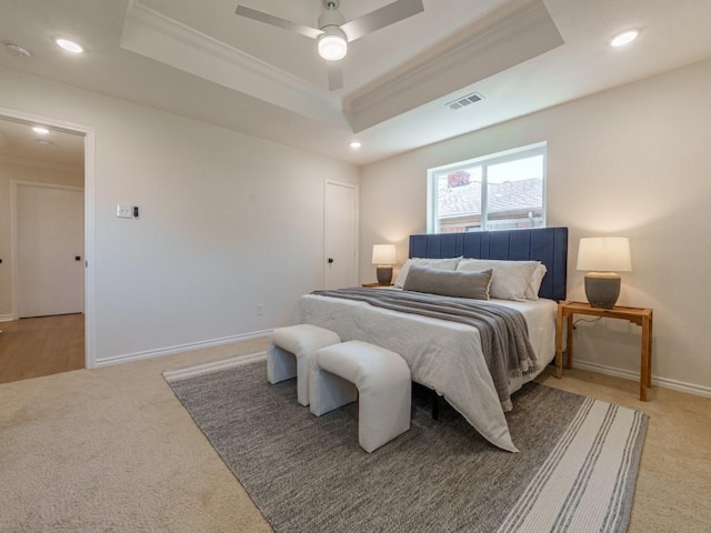 bedroom with visible vents, a raised ceiling, and ornamental molding