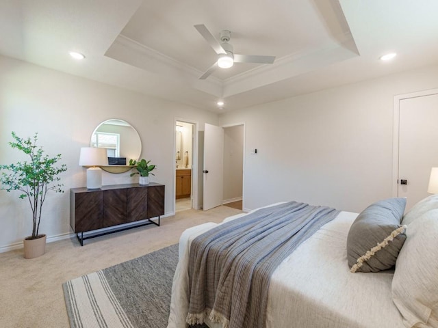 bedroom with a raised ceiling, recessed lighting, light colored carpet, and baseboards