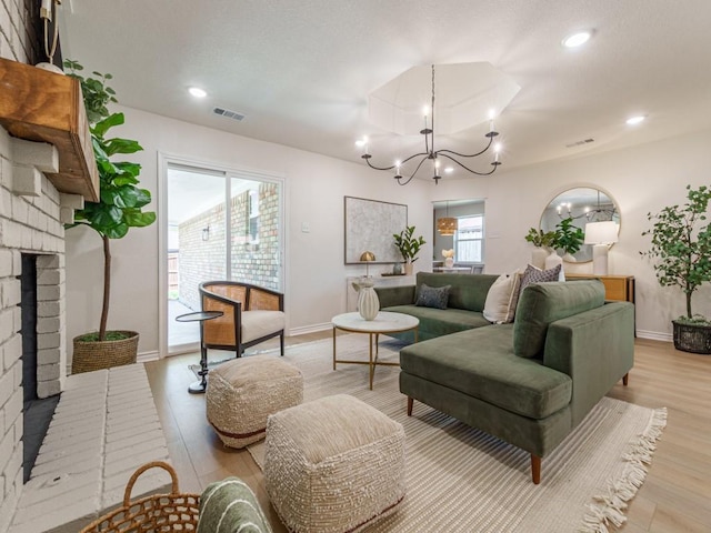 living area with a notable chandelier, recessed lighting, light wood-type flooring, and visible vents