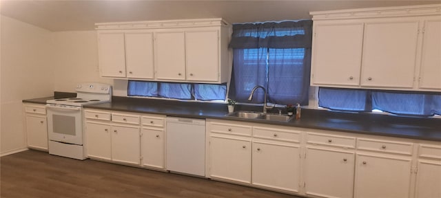 kitchen featuring dark countertops, white cabinets, white appliances, and a sink