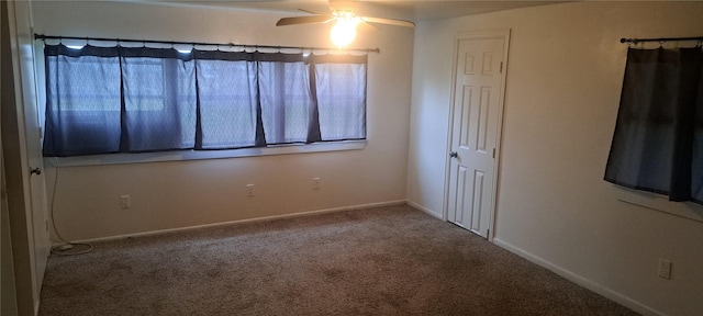 carpeted spare room with baseboards and ceiling fan