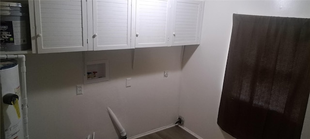 laundry room featuring baseboards, cabinet space, and washer hookup