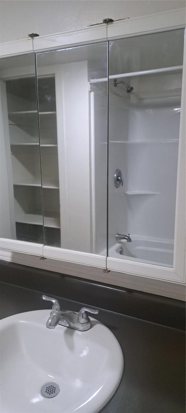 bathroom featuring shower / washtub combination and a sink