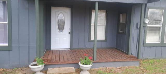 entrance to property with covered porch and board and batten siding