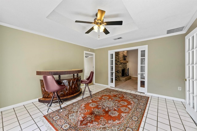 interior space featuring light tile patterned flooring, visible vents, french doors, and a tray ceiling