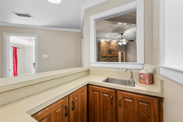 bathroom featuring crown molding, a ceiling fan, visible vents, and a sink