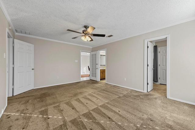 unfurnished bedroom with visible vents, ensuite bath, carpet flooring, and crown molding