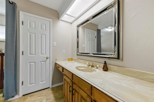 bathroom with vanity and baseboards