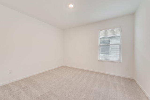 empty room with recessed lighting, baseboards, and light carpet