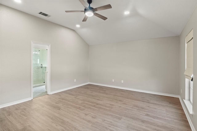 empty room featuring light wood finished floors, visible vents, baseboards, vaulted ceiling, and a ceiling fan