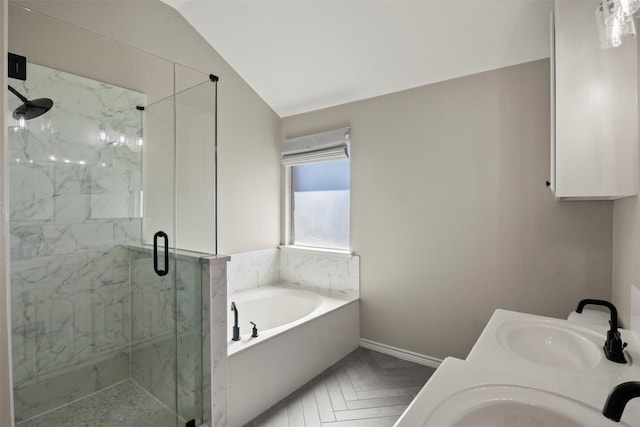 bathroom featuring a sink, a marble finish shower, a garden tub, and vaulted ceiling