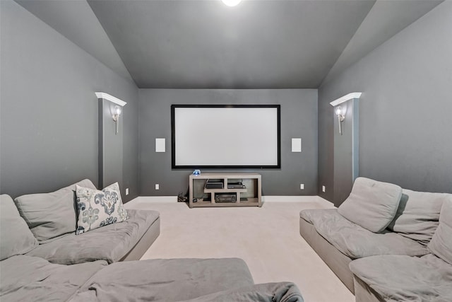 home theater room with vaulted ceiling, baseboards, and carpet floors