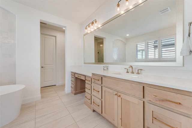 full bathroom with visible vents, a soaking tub, vanity, and tile patterned flooring